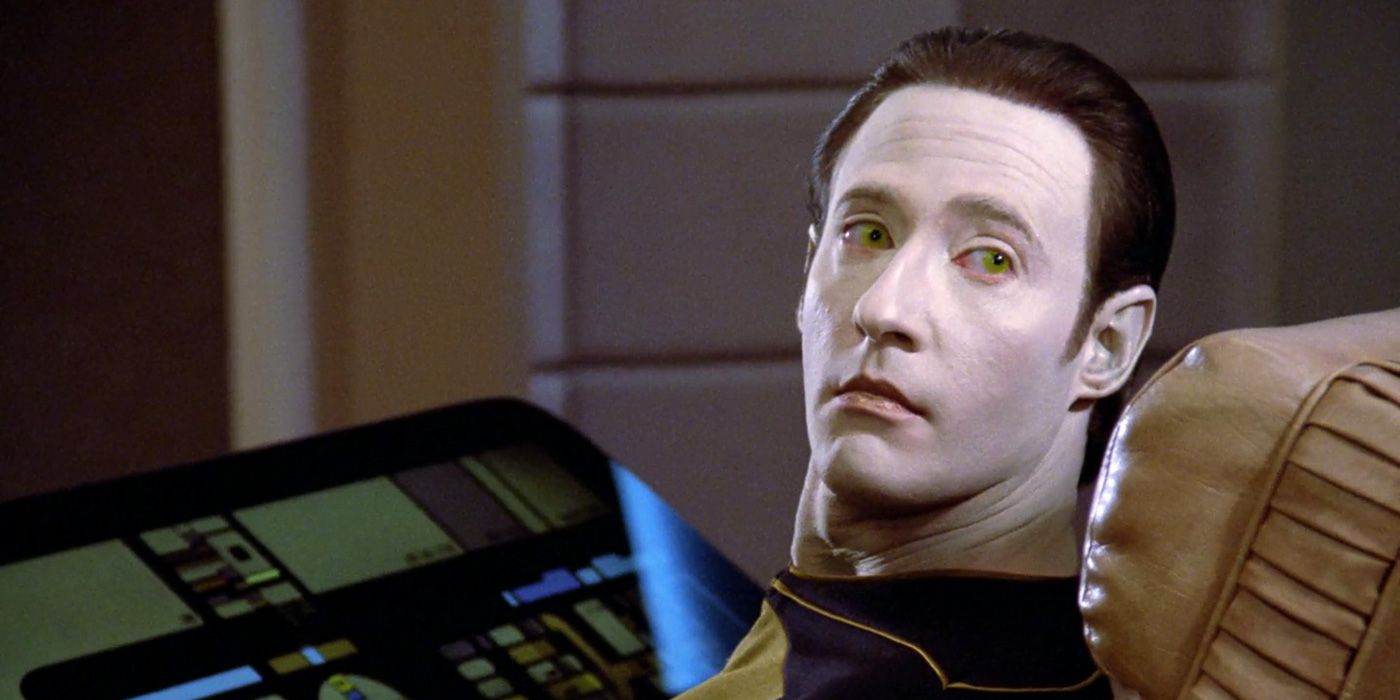 Data -
the android from Star Trek TNG
sitting at the console,
and looking back at the camera
with golden eyes
