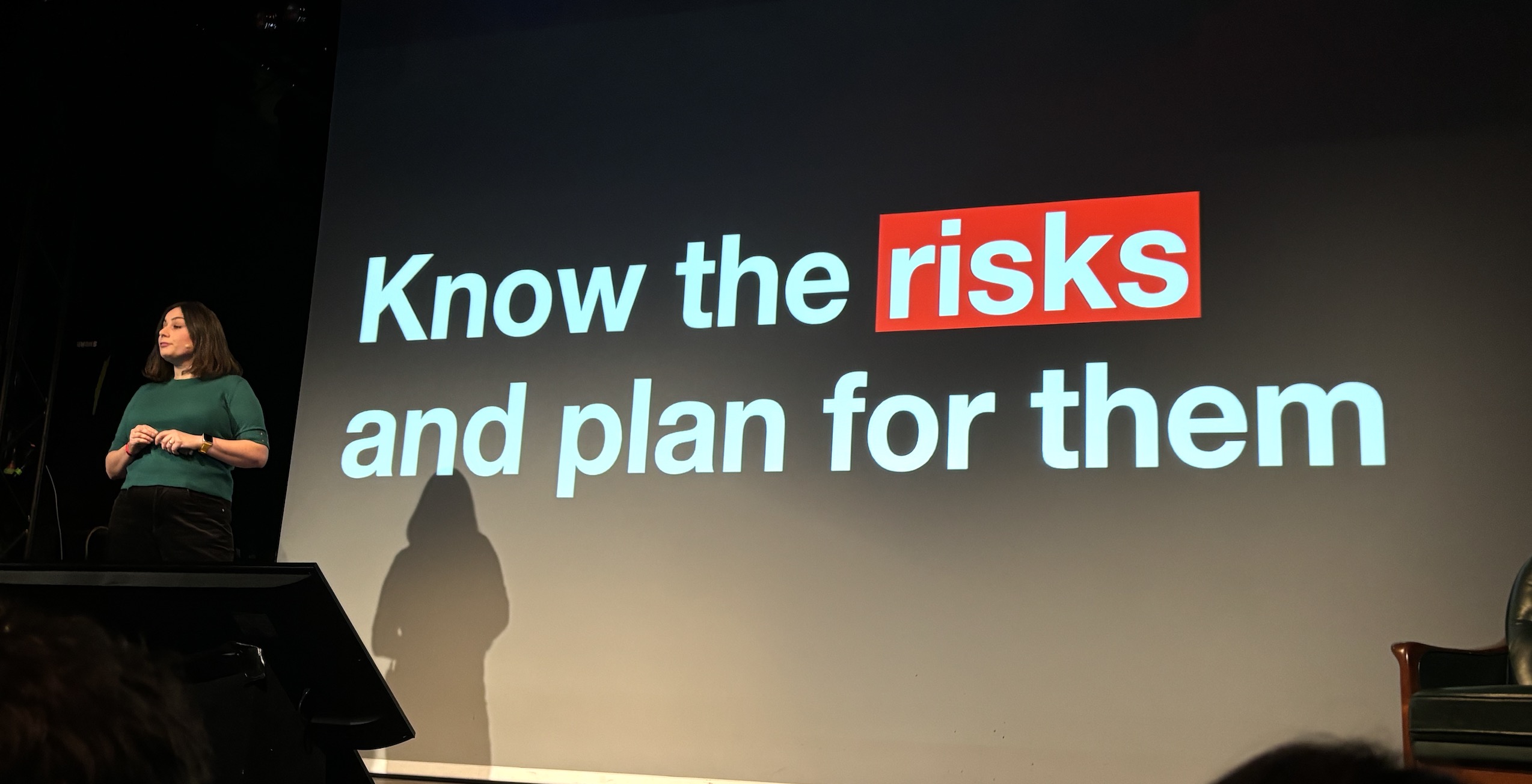 Sophie in front of a slide that says know the risks and plan for them
